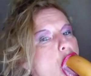 The horny granny takes big dildo all the way in her mouth
