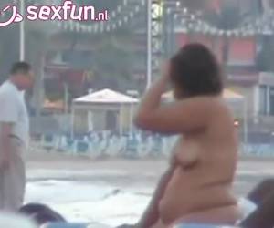 Porra casal numa praia envia um visualizador distância